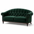 Sofá de terciopelo verde con patas de madera